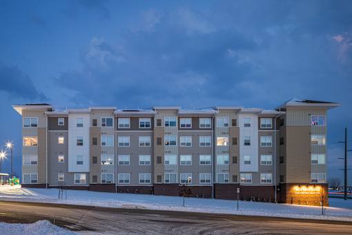 A large building with a parking lot in front of it.