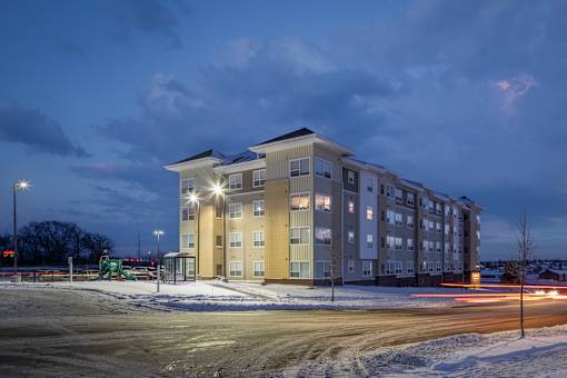 A large building with a parking lot in front of it.