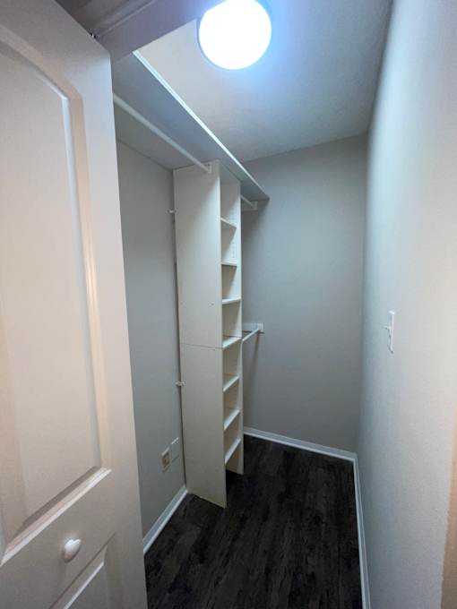 A small room with a white door and a staircase.