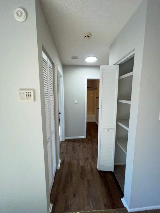 A long hallway with a door at the end.