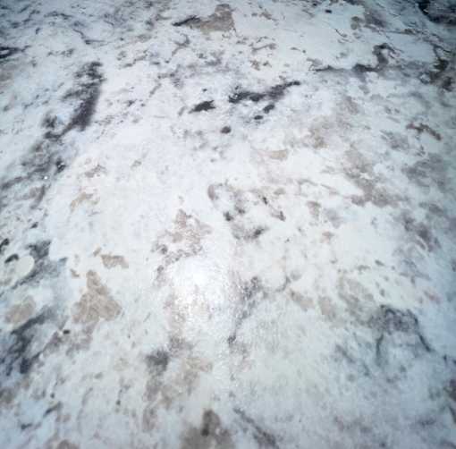 A close up of a white and brown marbled surface.