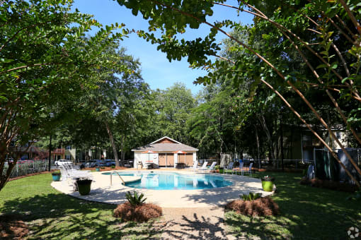 a backyard with a pool and a pool house