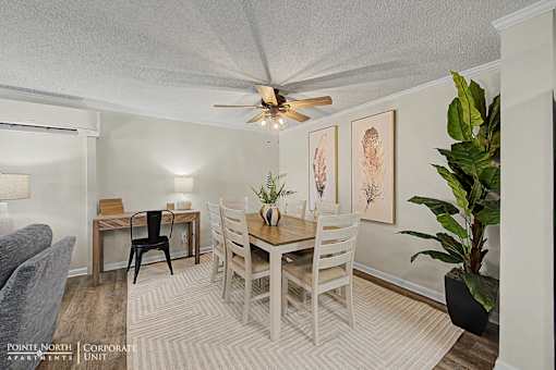 A dining room with a table and chairs.