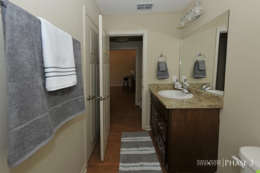 a small bathroom with a sink and a mirror and a shower