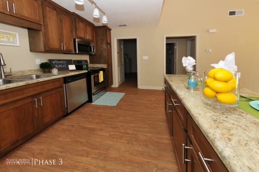 a kitchen with wooden cabinets and a counter top with lemons