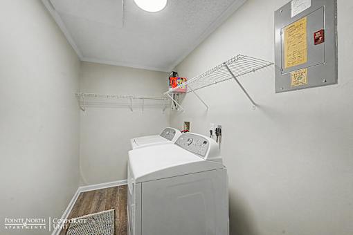 A white washing machine in a small laundry room.
