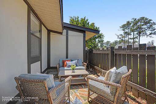 A patio with a table and chairs is shown.