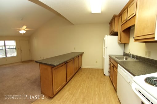 an empty kitchen with a stove refrigerator and sink