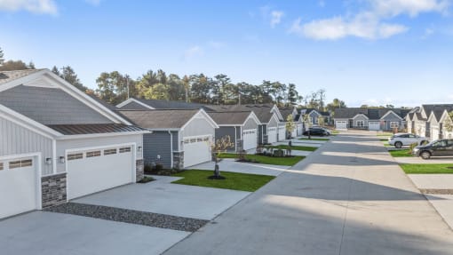a row of houses with cars parked in front of them