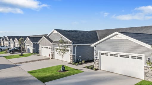 a row of gray and white houses in a neighborhood