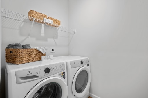 a laundry room with a washing machine and a basket on top of it
