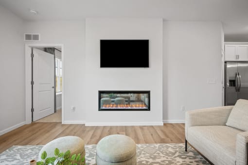 a living room with a fireplace and a tv on the wall