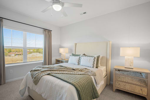 a bedroom with a bed and a ceiling fan