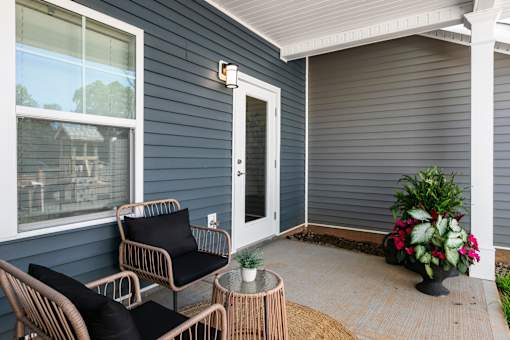 A patio with a chair and a table.