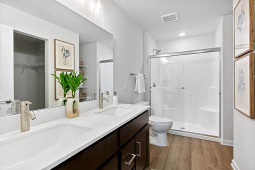 A bathroom with a white sink and a toilet.