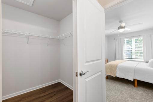 A white bedroom with a bed and a window.