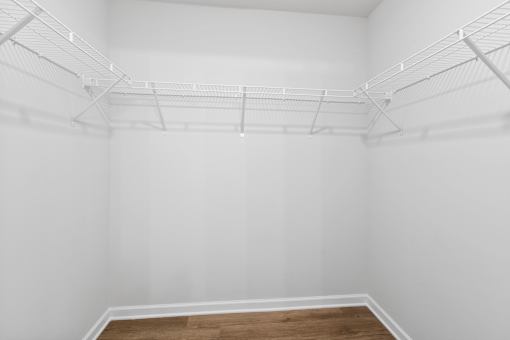 Empty room with white walls and wooden floor.