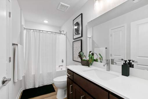 A bathroom with a white toilet and a white sink.