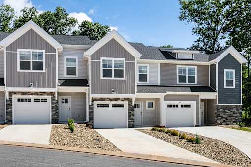 A row of houses with garages in front.