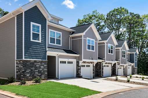 A row of houses with garages are shown in the image.