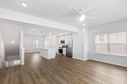 A spacious kitchen with a refrigerator, sink, and stove.