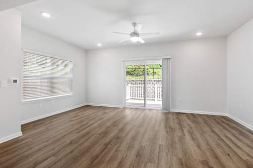 A room with wooden flooring and a ceiling fan.