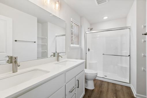 A white bathroom with a walk-in shower.