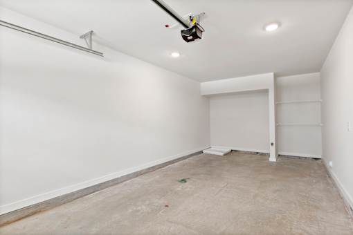 A room with a white door and a white wall.