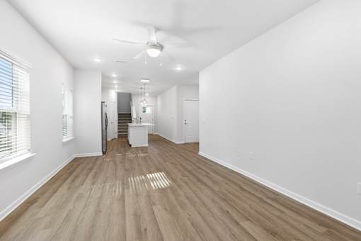 A room with wooden flooring and white walls.
