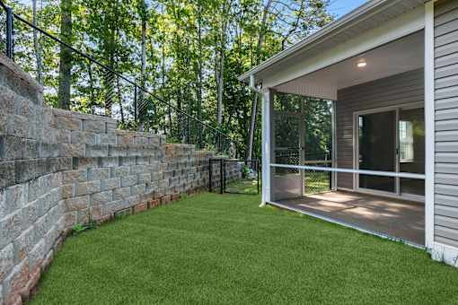 A house with a stone wall and a glass door.