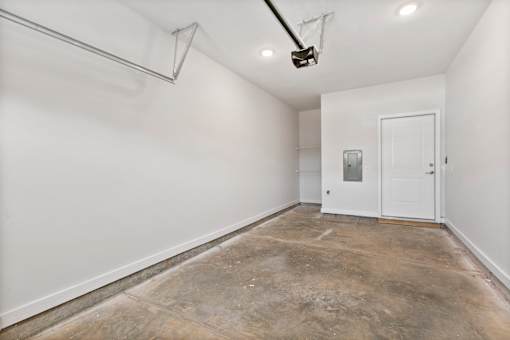 A room with a white door and a white wall.