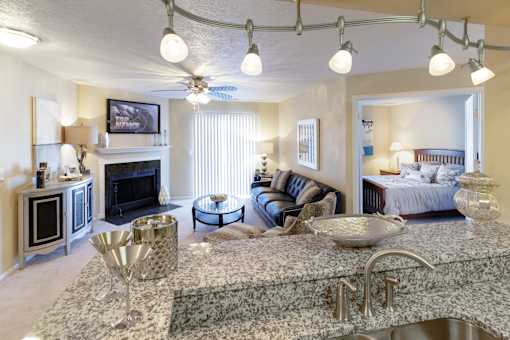 A living room with a fireplace and a television.