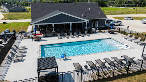 A pool with a black fence and a black and white striped poolside.