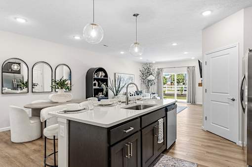 A modern kitchen with a large island and a view of the backyard.