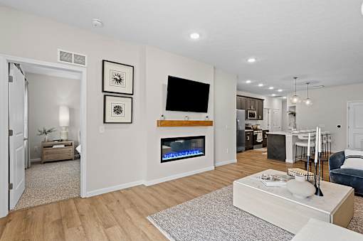 A modern living room with a fireplace and a television.
