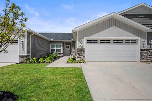 A modern house with a grey garage door.