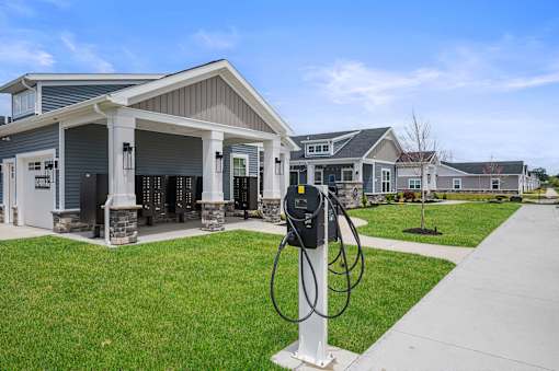 A charging station for electric vehicles is located in front of a building.