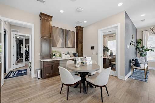 A dining room with a table and chairs.