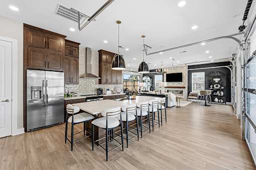 A modern kitchen with a large island and stainless steel appliances.