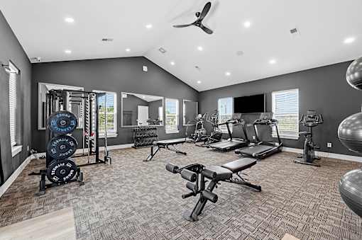A spacious home gym with a variety of equipment.