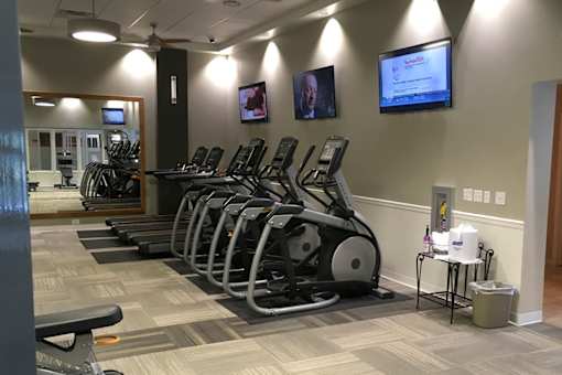 A gym with treadmills and exercise bikes.