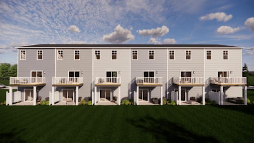 A row of identical houses with balconies.
