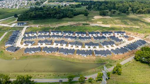A large housing development with a lake in the middle.