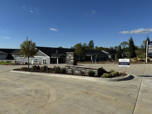 an empty parking lot in front of a house