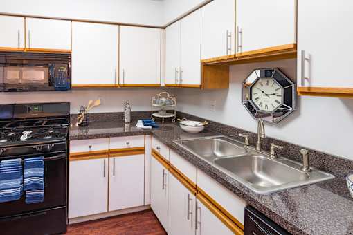 A kitchen with a black stove and a black dishwasher.