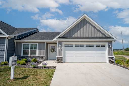 A house with a garage and a sign that says "MORE".