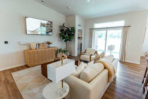 A living room with a white couch and a wooden coffee table.