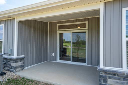 A house with a grey exterior and a glass door.