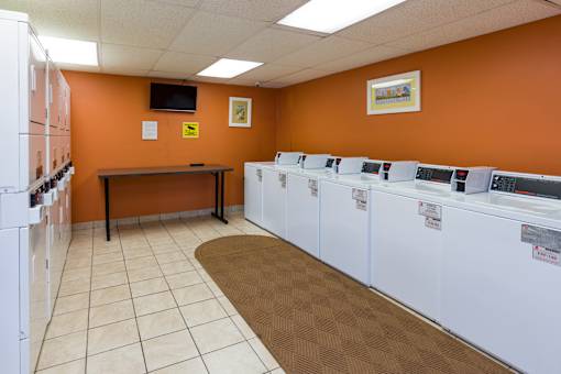 A laundromat with rows of washers and dryers.