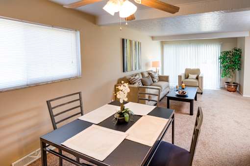 A dining room with a table set for two.